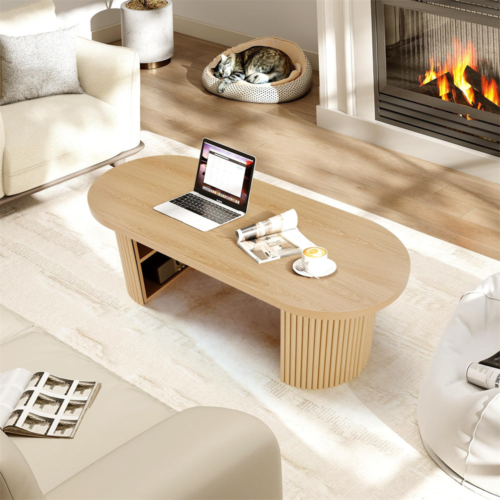 Modern living room with a wooden coffee table, laptop, and fireplace.