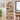 Wooden bookshelf with various items in a room with a window and plant