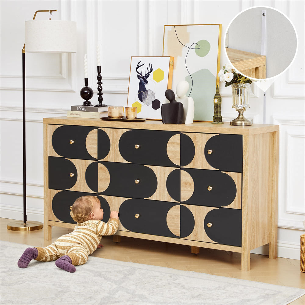 Child playing with a wooden dresser with black geometric pattern in a room.