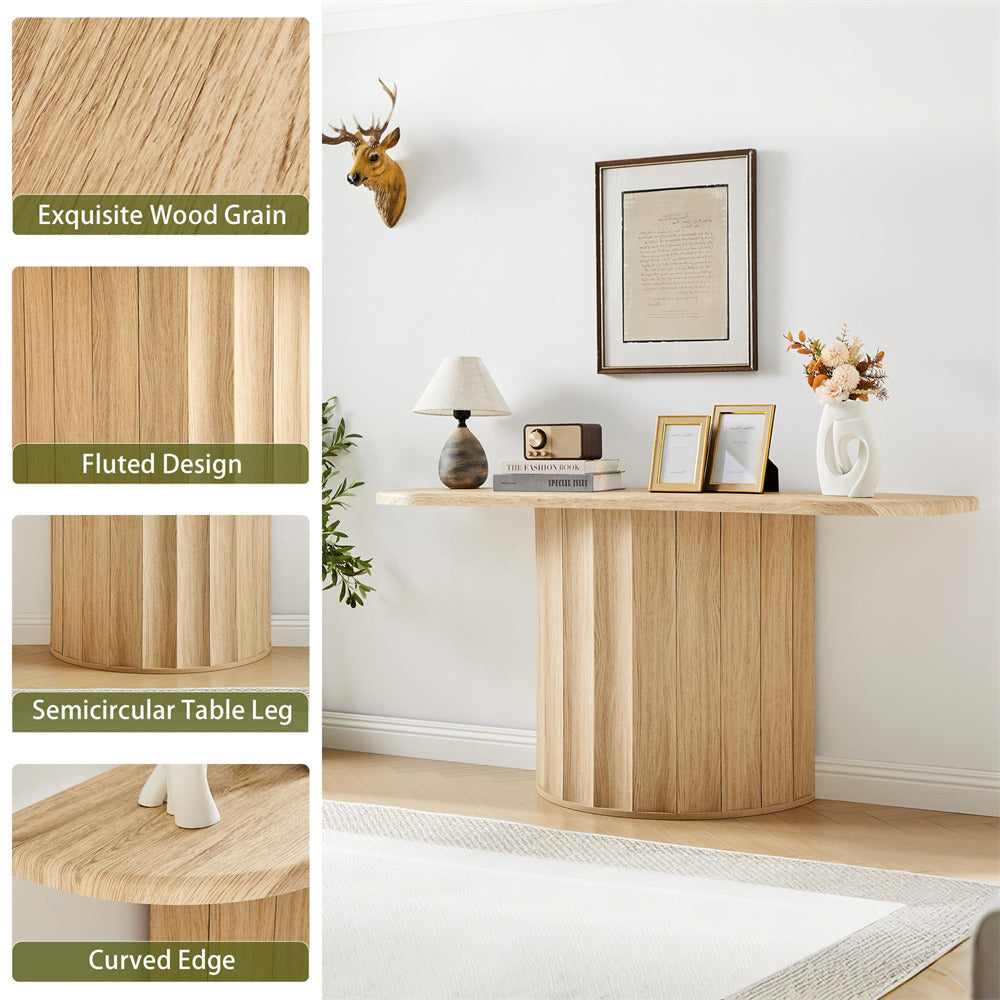 Wooden table with fluted design and semicircular leg in a room setting.