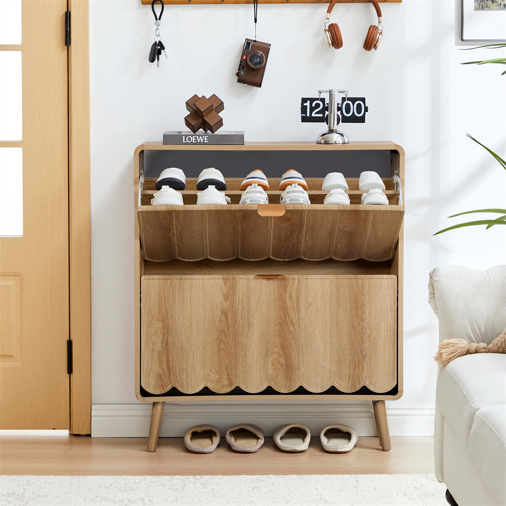 Wooden shoe cabinet with shoes inside, placed in a room with a white wall and a door.