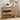 Wooden shoe cabinet with open shelves displaying shoes, a small clock, and decorative items on a wall.