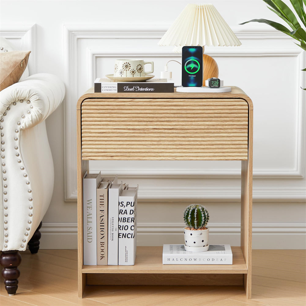 Wooden side table with books, a cactus, and decorative items in a room setting.