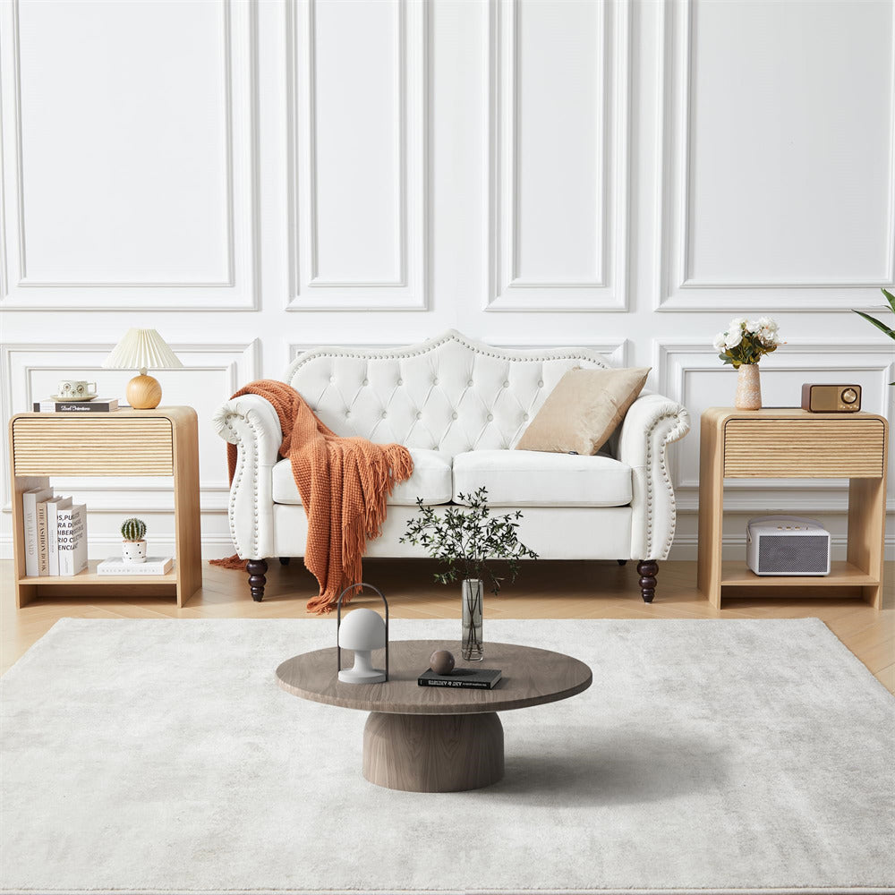Modern living room with a white sofa, wooden coffee table, and decorative items.
