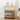 Wooden nightstand with decorative items including a clock, lamp, and speaker in a bedroom setting.