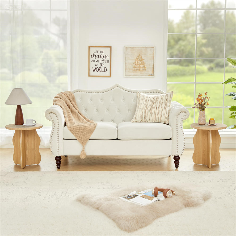 Living room with a white sofa, side tables, and decor elements.