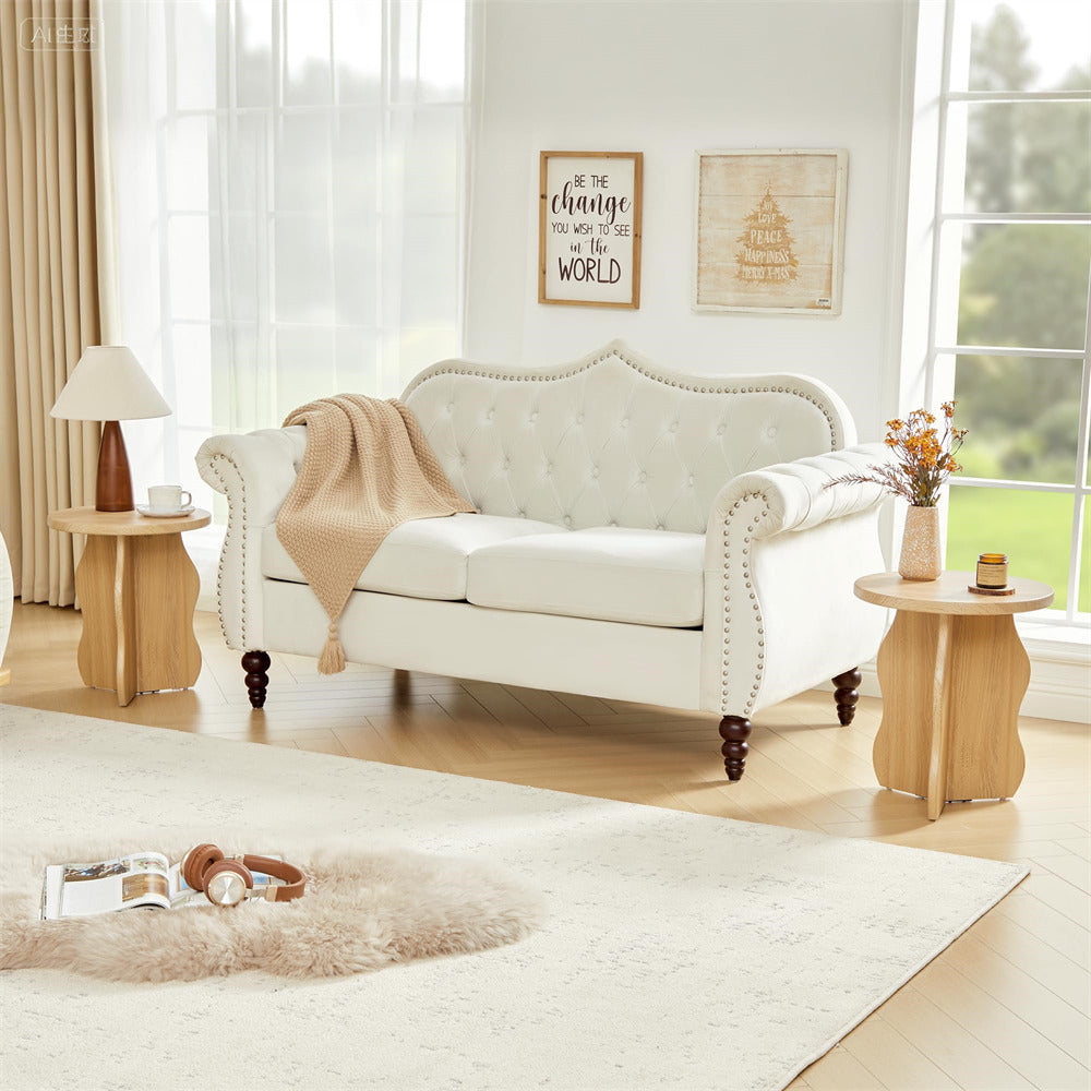 Living room with a white sofa, wooden side tables, and decorative elements.