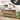 Wooden shoe bench with high-density seat cushions, shoes, and bags on a light wooden floor.