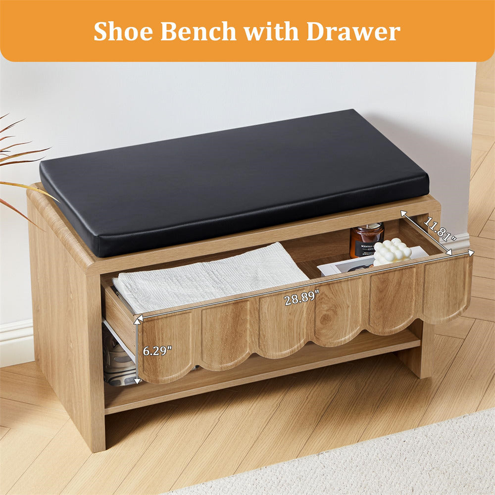 Wooden shoe bench with black cushion and open drawer on a wooden floor.
