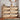 Wooden shoe cabinet with open drawers filled with shoes in a room setting.