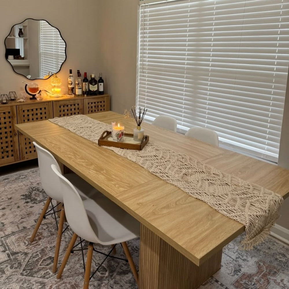 Dining room with a wooden table, chairs, and decorative items.