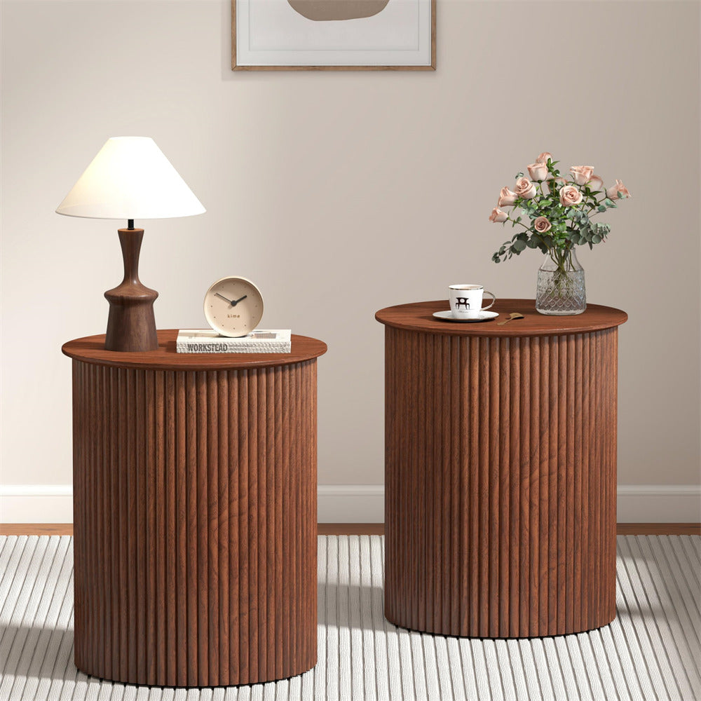 Two wooden side tables with decorative items in a room setting.