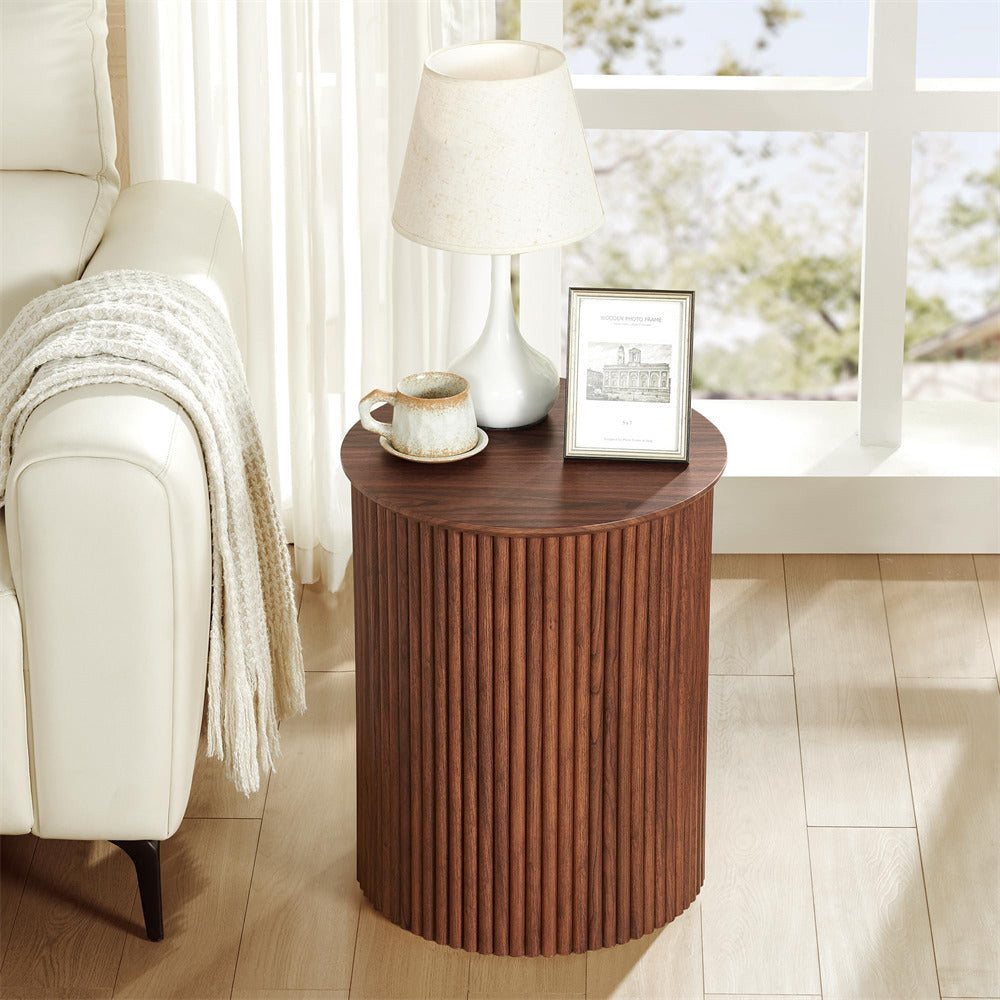 Wooden side table with a lamp, mug, and picture frame in a living room setting.