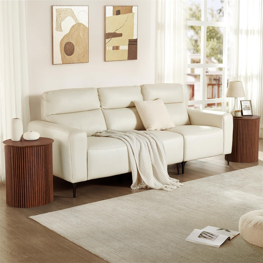 Beige sectional sofa in a living room with wooden side tables and abstract art on the wall.