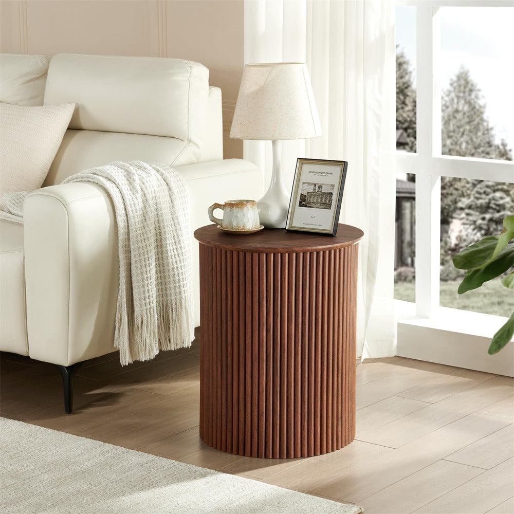 Wooden side table in a living room with a lamp and decorative items.