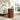 Wooden side table in a living room with a lamp and decorative items.