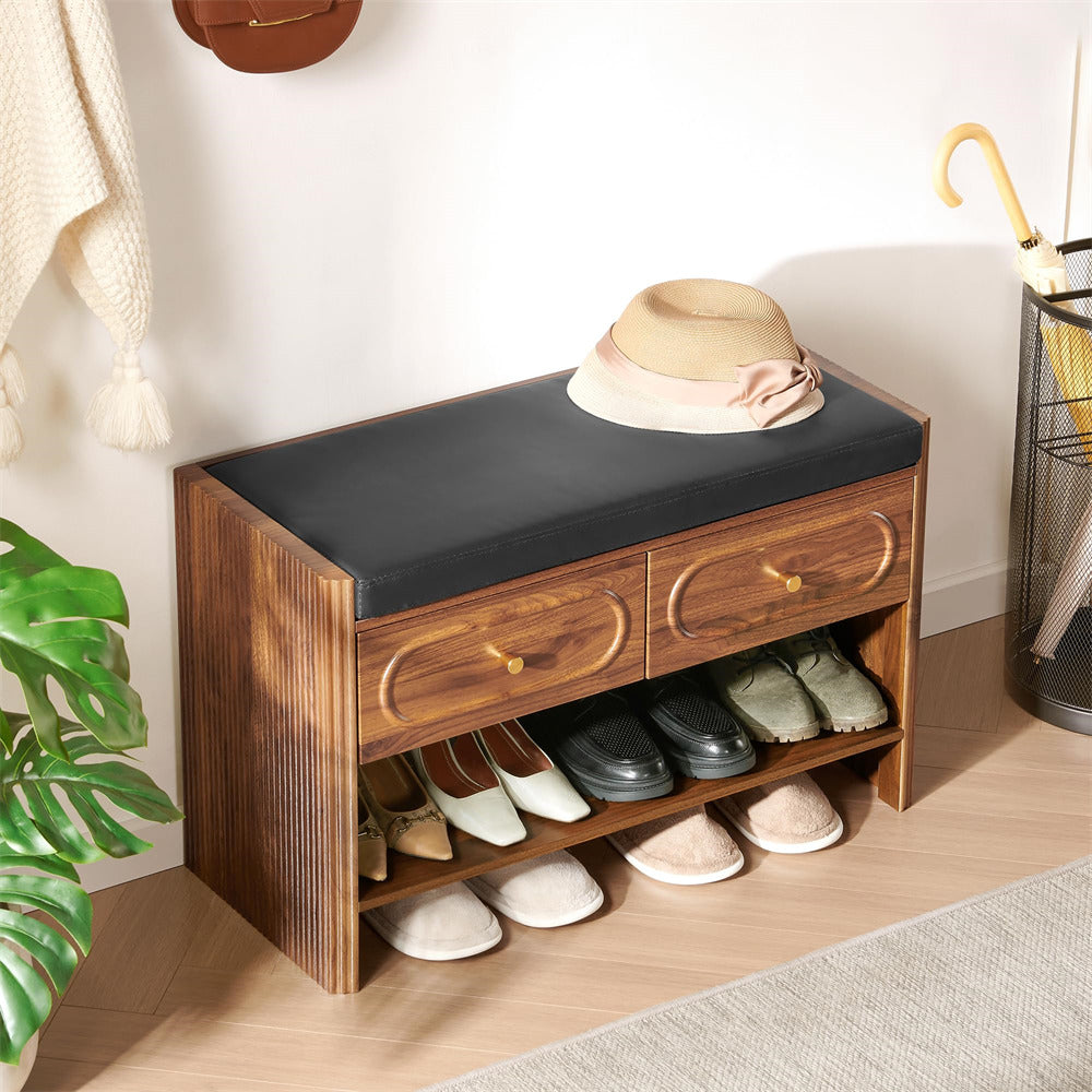 Wooden shoe bench with black cushion, shoes, and a hat in a home setting.