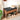 Wooden shoe bench with black cushion, shoes, and a hat in a home setting.