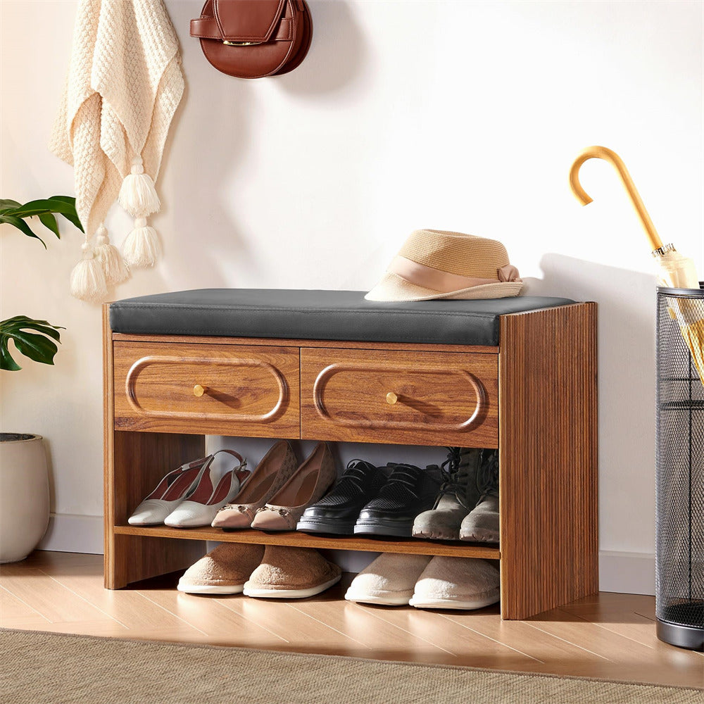 Wooden shoe bench with shoes underneath, a hat on top, and an umbrella to the side.