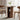 Wooden dining table with storage shelves in a room with curtains and chairs.