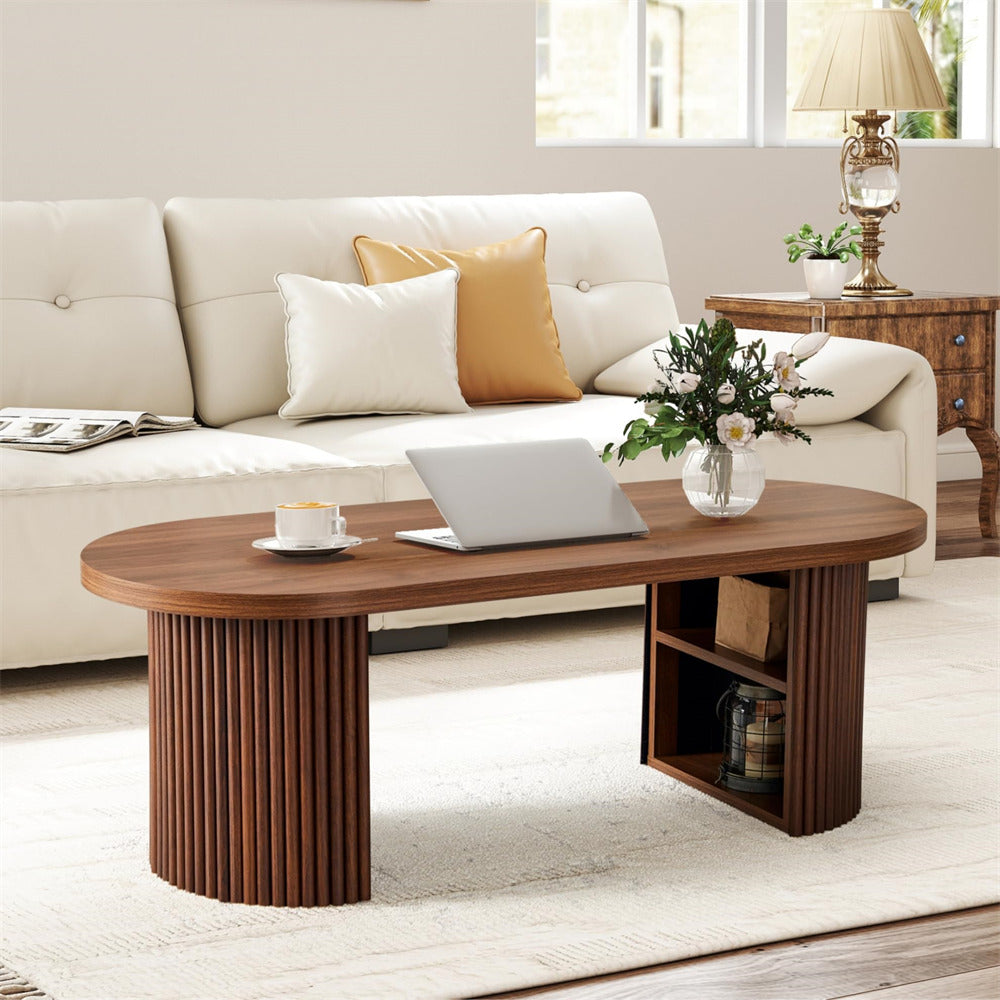Wooden coffee table with a laptop, cup, and decorative items in a living room setting.