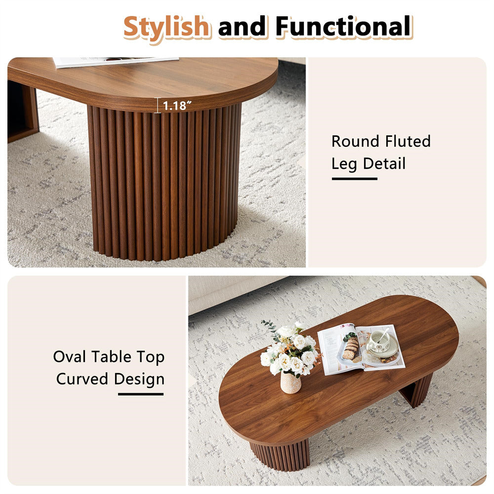 Wooden coffee table with round fluted legs and oval table top, shown on a light background.
