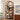 Wooden arch-shaped bookshelf with decorative items in a room setting.