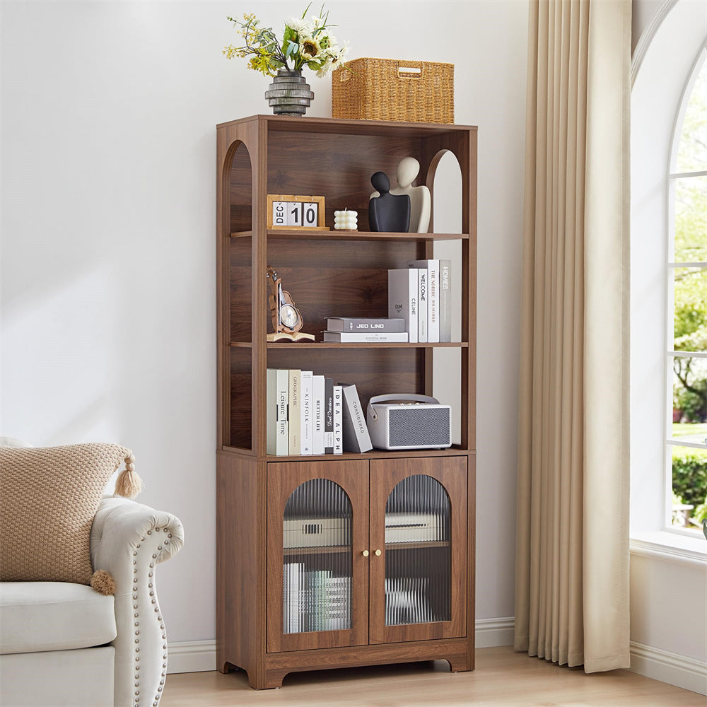 Wooden bookshelf with decorative items in a room with a window and sofa.
