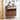 Wooden shoe cabinet with open door displaying shoes, slippers on the floor, and decor items on a white wall.