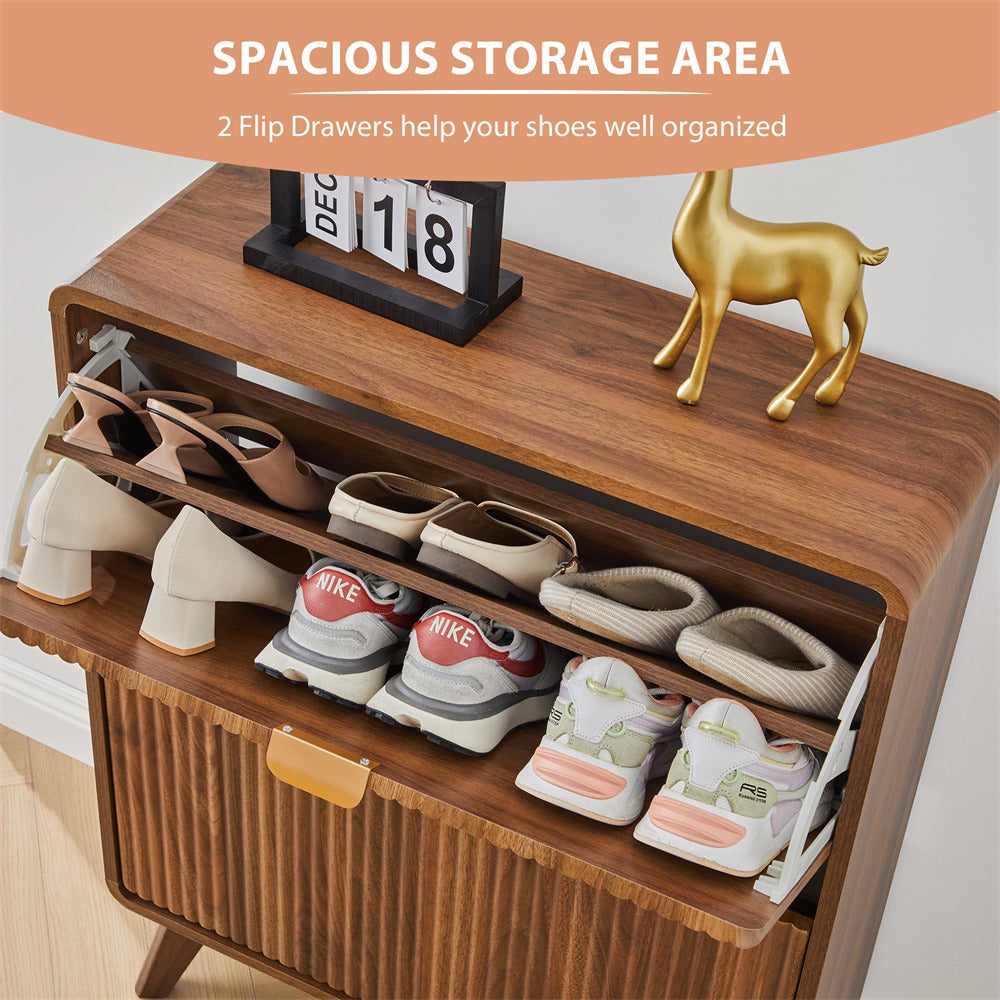 Wooden shoe storage cabinet with open drawers displaying various shoes, with a calendar and decorative deer figurine on top.
