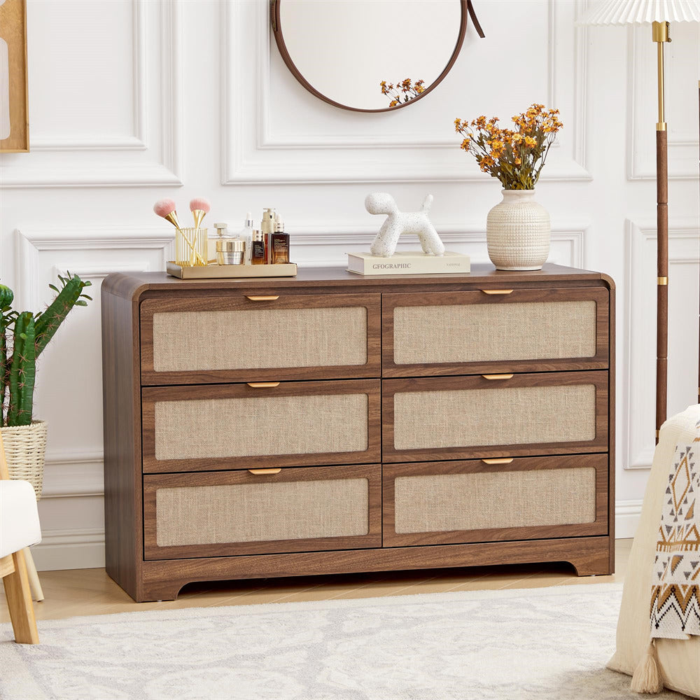 Wooden 6 drawer dressers with decorative items in a room setting