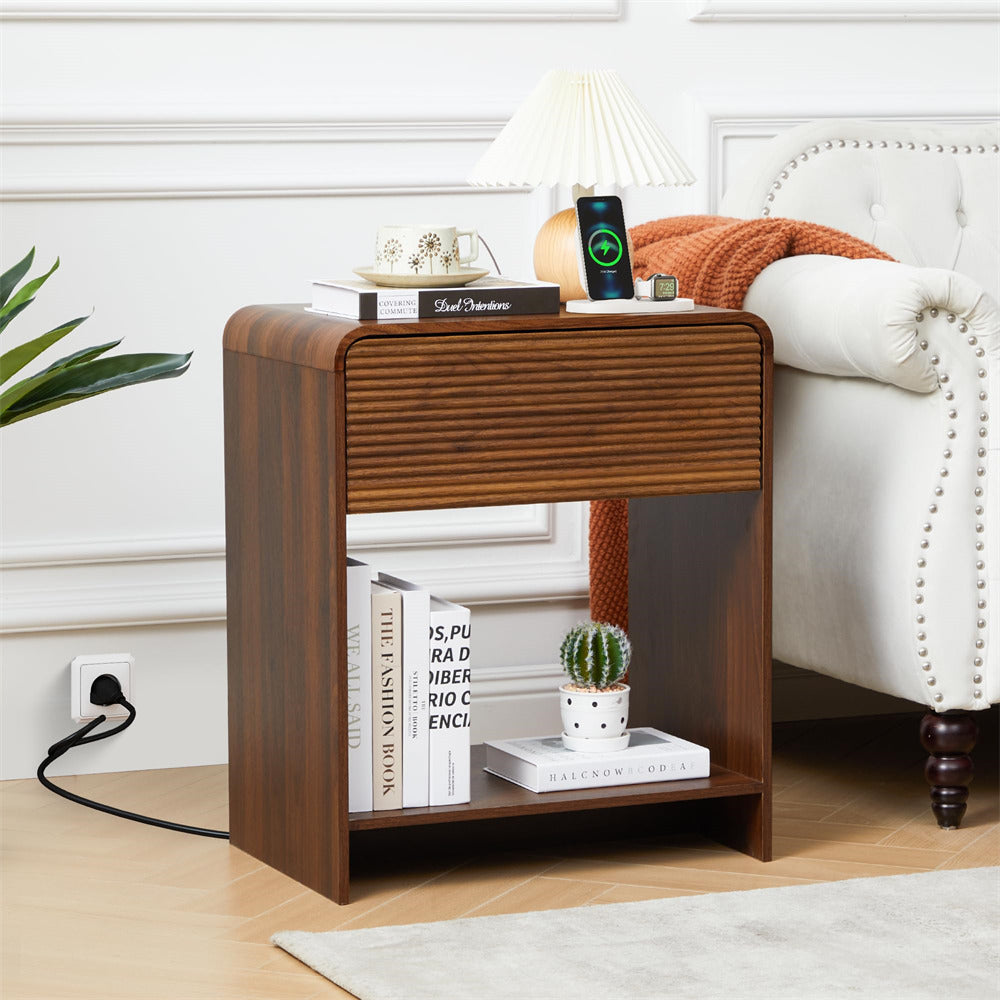 Wooden side table with books, a plant, and a smartphone in a living room setting.