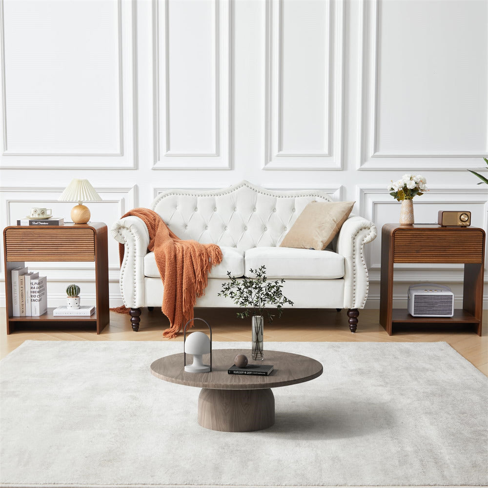 Living room with a white sofa, wooden coffee table, and side tables.