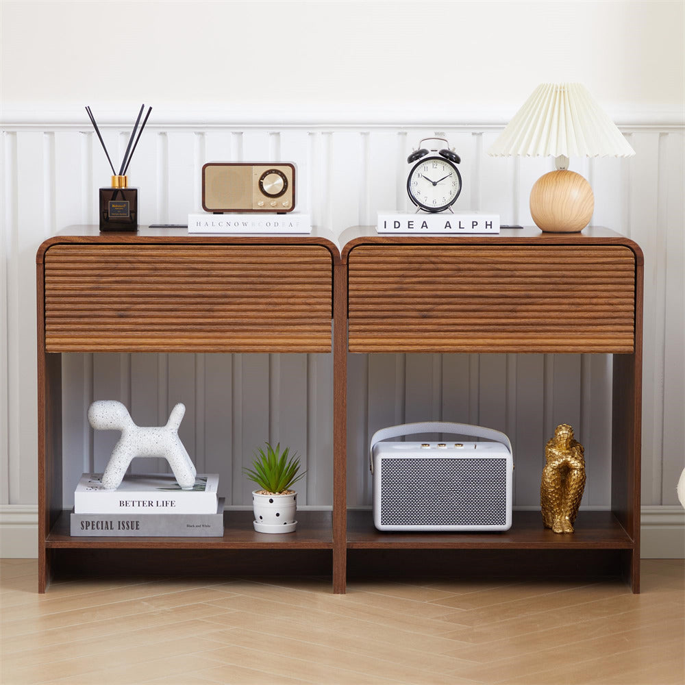 Wooden console table with decorative items against a white wall.