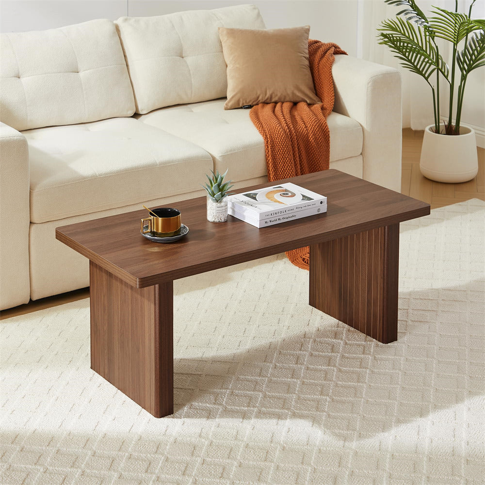 Wooden coffee table with decorative items in a living room setting