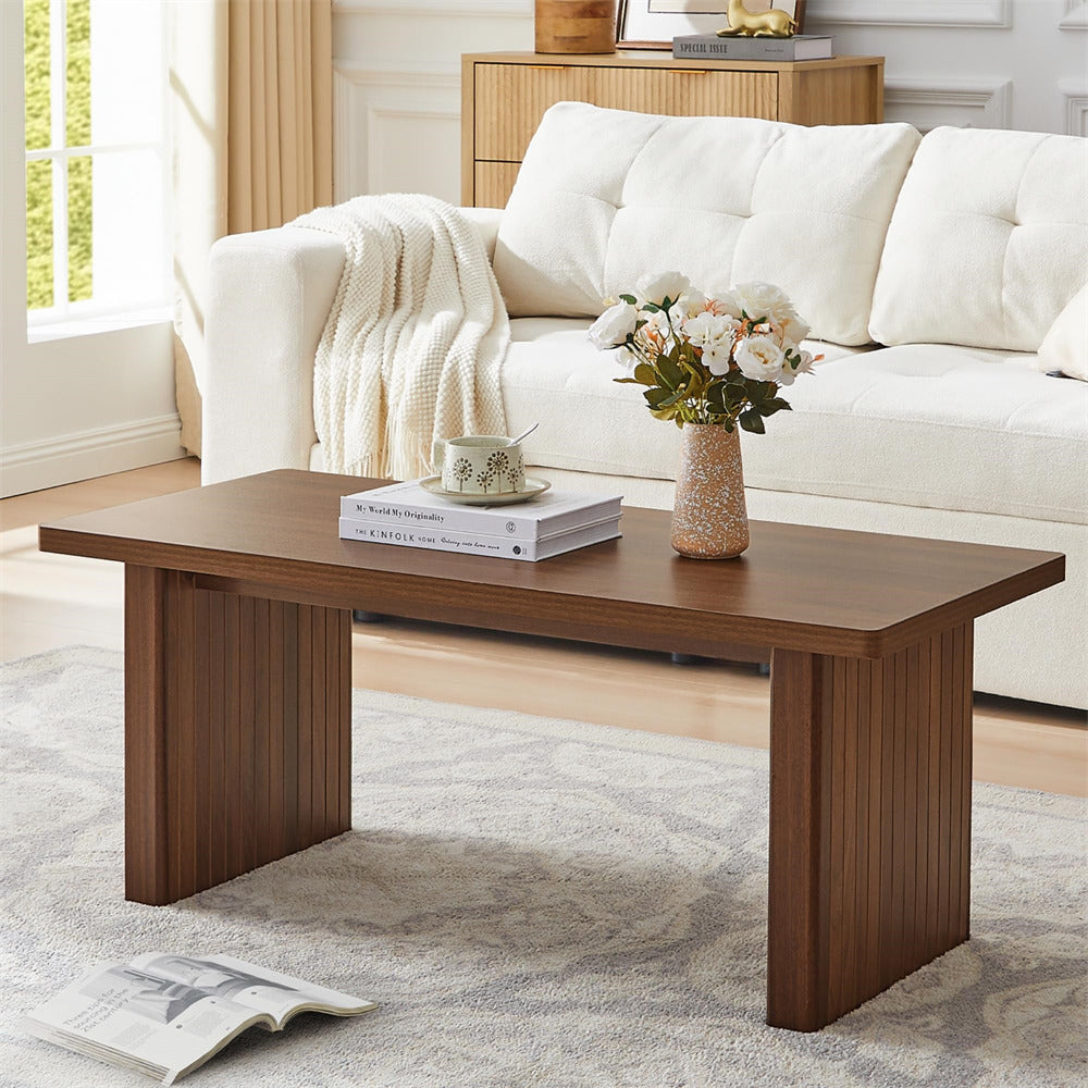Wooden coffee table with decor items in a living room setting