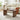Wooden coffee table in a living room with a beige sofa and decorative items.