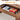 Wooden desk with an open drawer containing snacks and gaming controllers, labeled 'Easy Storage'.