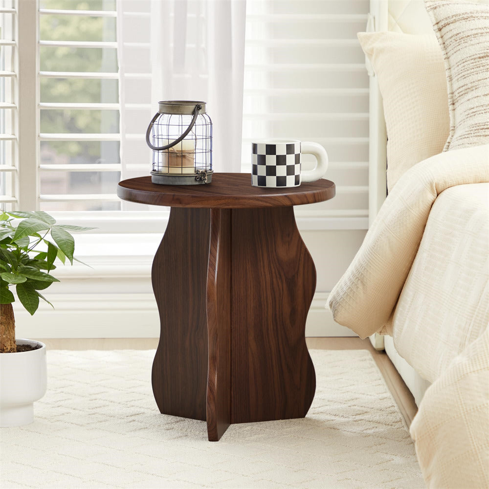 Wooden side table with a checkered mug and lantern in a bedroom setting