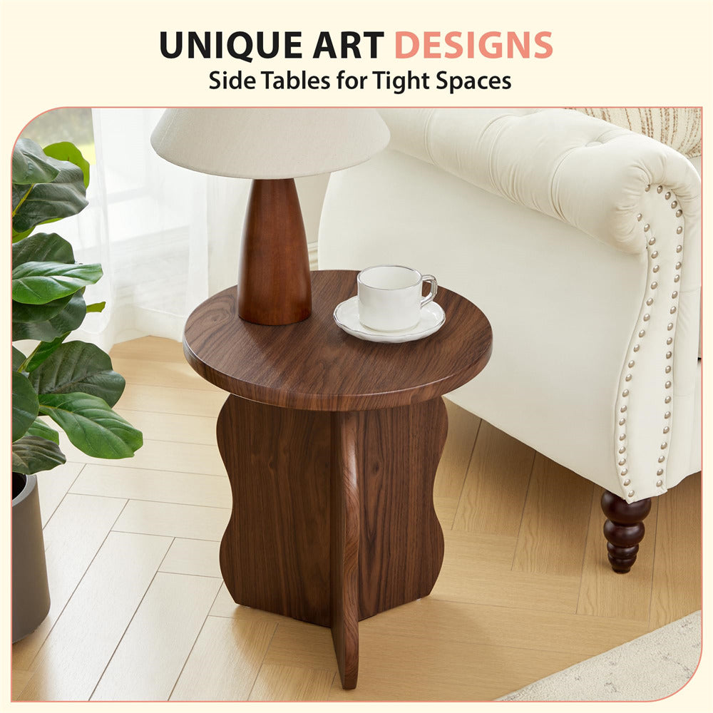 Wooden side table with a cup and saucer next to a white sofa and plant.