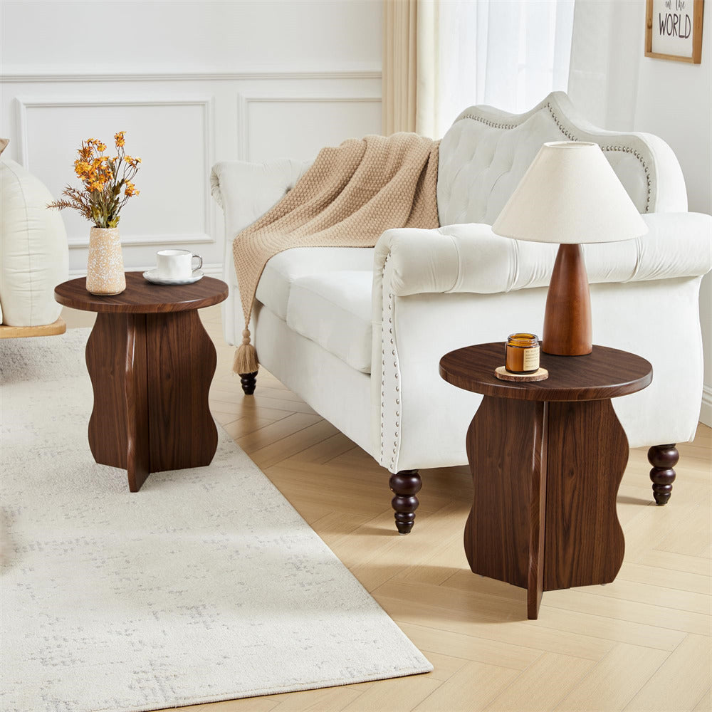 White sofa with wooden side tables and decorative items in a living room setting.