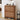 Wooden shoe cabinet with two drawers, shoes inside, and decor items on top in a room setting.