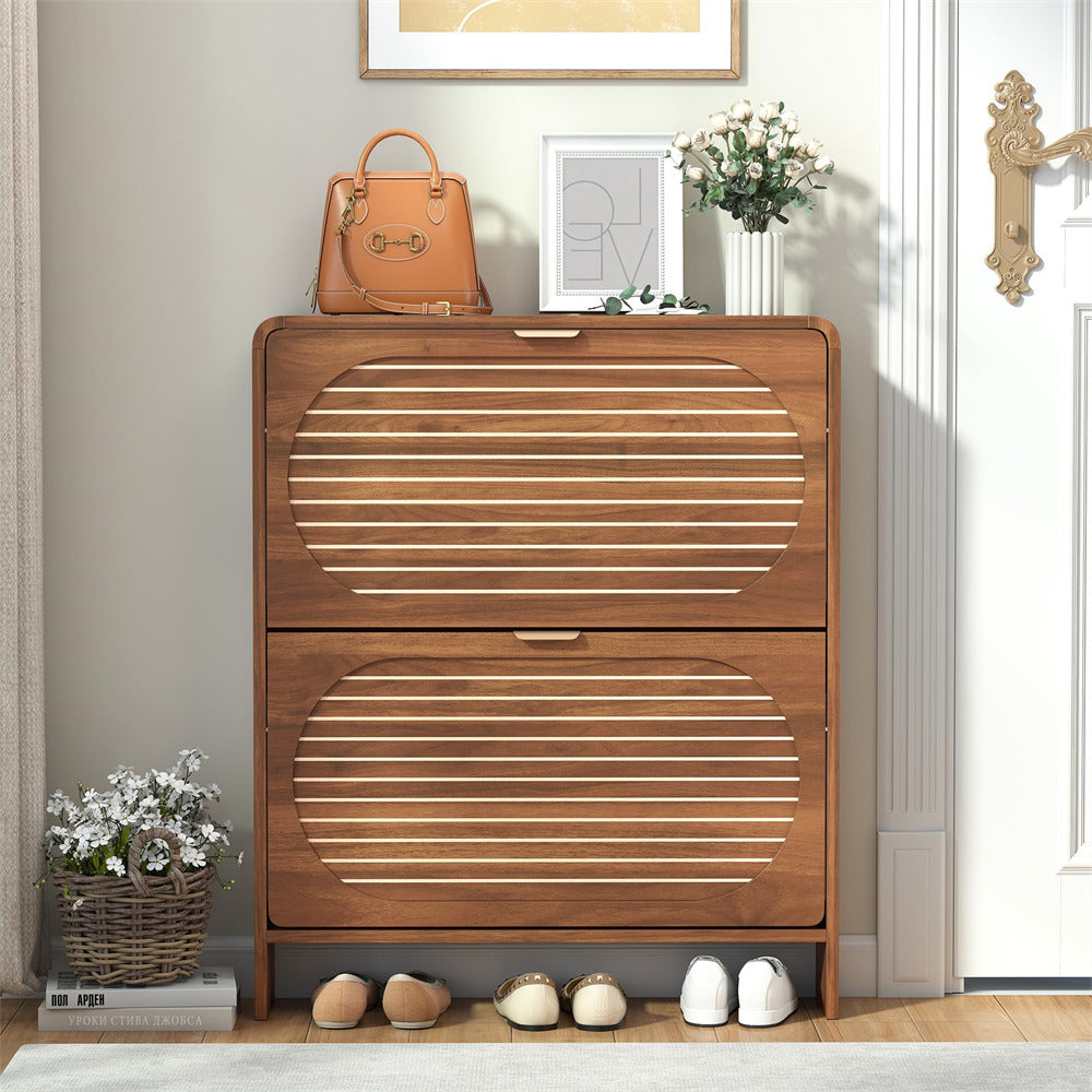 Wooden shoe cabinet with two drawers in a room setting.