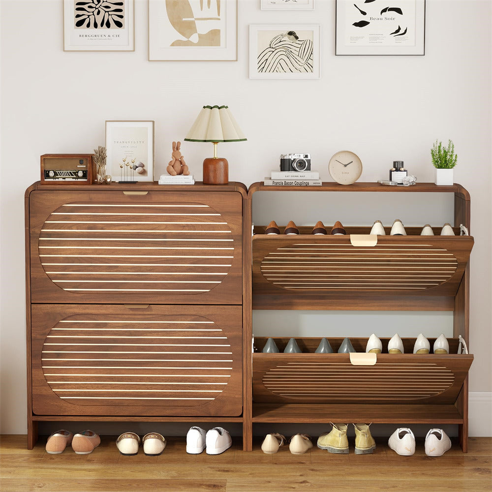 Wooden shoe cabinet with multiple compartments filled with shoes, placed against a wall with decorative items.