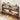 Wooden shoe rack with various shoes on a wooden floor.