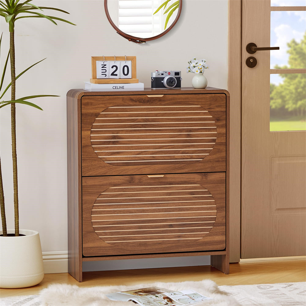 Wooden cabinet with two drawers in a room with a plant and a door.