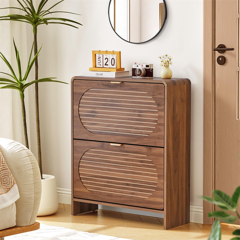 Wooden side table with two drawers in a room setting with decor items.