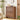 Wooden side table with two drawers in a room setting with decor items.
