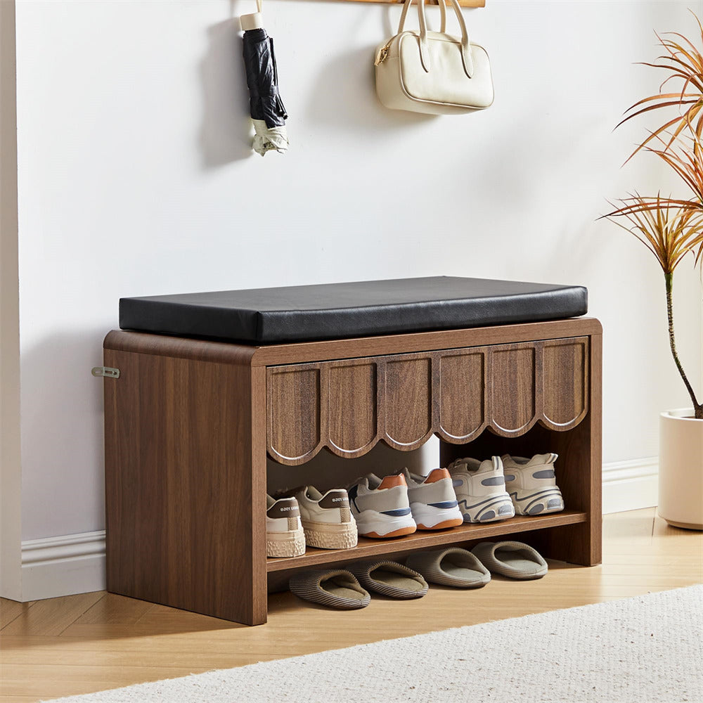 Wooden shoe storage bench with black cushion, shoes, and bags on a light wooden floor.