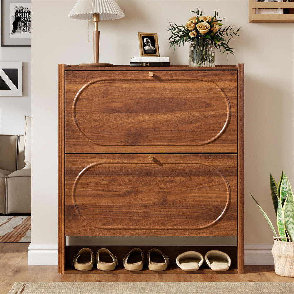 Wooden shoe cabinet with two drawers and shoe compartments in a room setting.